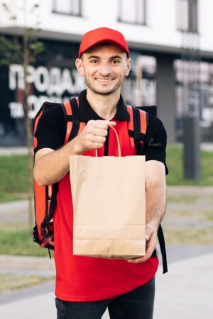 food-delivery-man-order-from-restaurant-handsome-young-man-tshirt-cap-happy-delivery_153228-1878